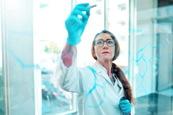 Employee_Female Scientist Writing On Board