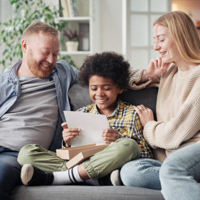 Happy child reading a letter about adoption