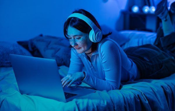 Teenage girl using laptop for online communication